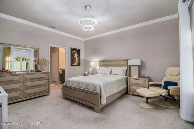 a bedroom with a bed and lamp