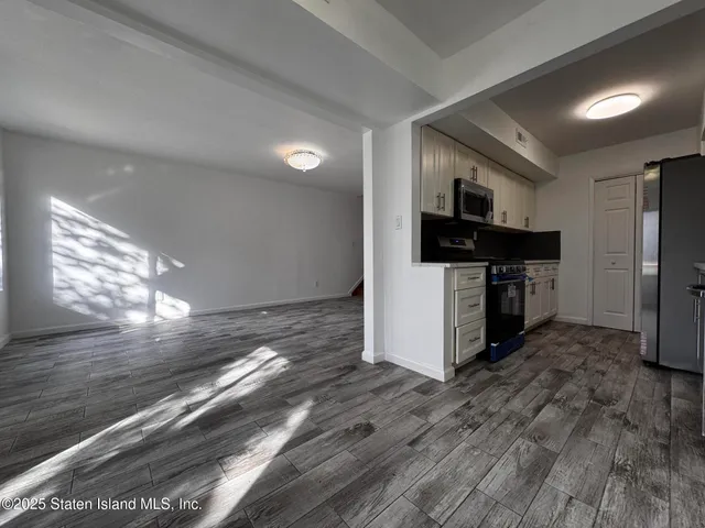 a kitchen with granite countertop a stove and a refrigerator