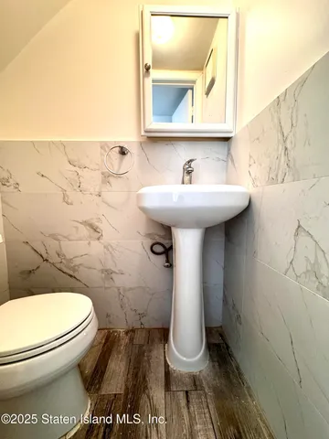 a bathroom with a sink toilet and mirror