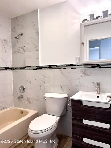 a bathroom with a toilet a sink and bathtub