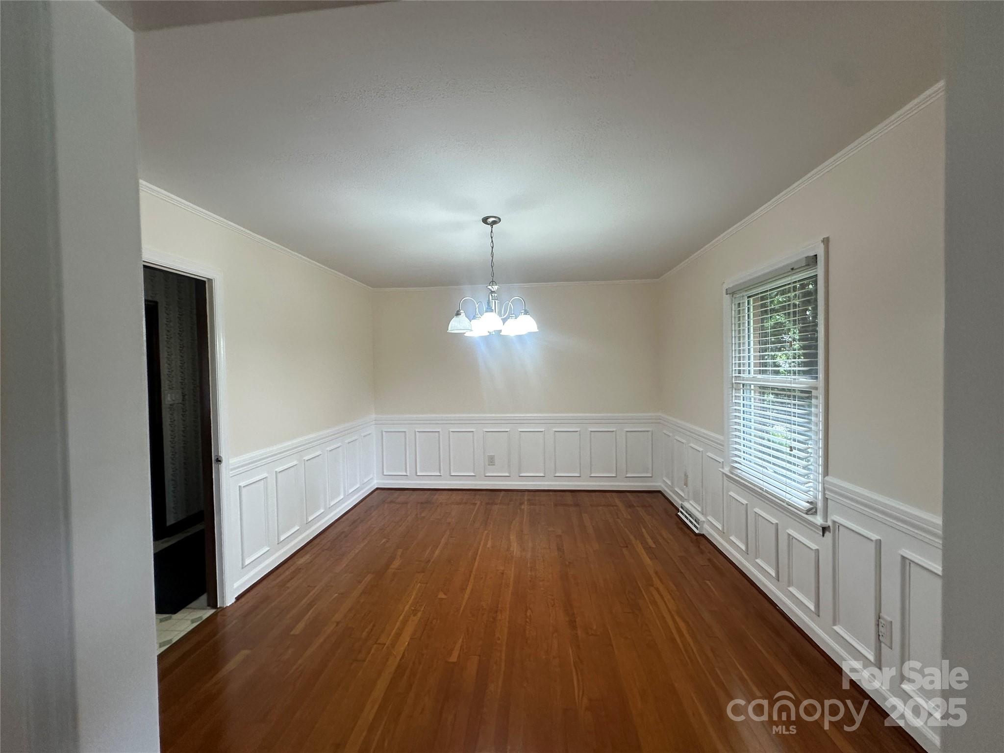 1115 Dumbarton Road Gastonia, NC 28054 - Photo 12 of 20 wooden floor in an empty room with a window