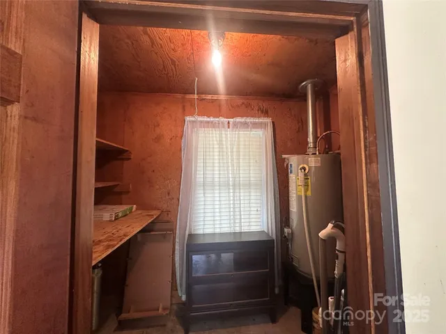 a bathroom with a light fixture a sink and a mirror