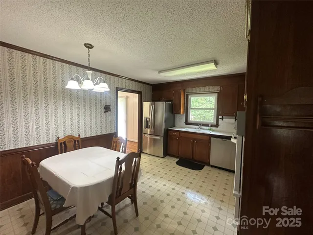 a kitchen with a sink a stove a refrigerator and cabinets