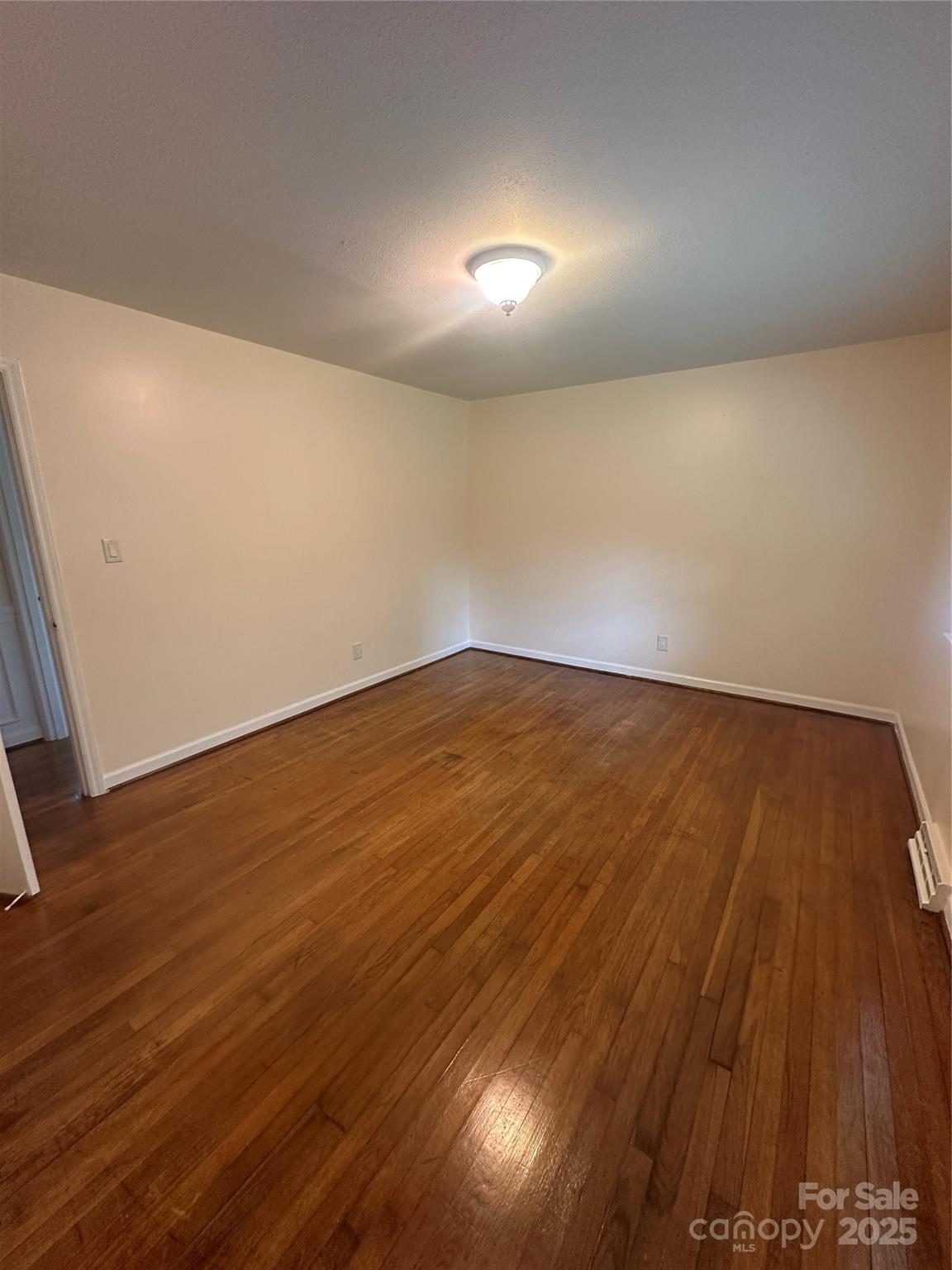 1115 Dumbarton Road Gastonia, NC 28054 - Photo 5 of 20 an empty room with wooden floor and windows