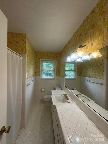 a room with a bed and a chandelier