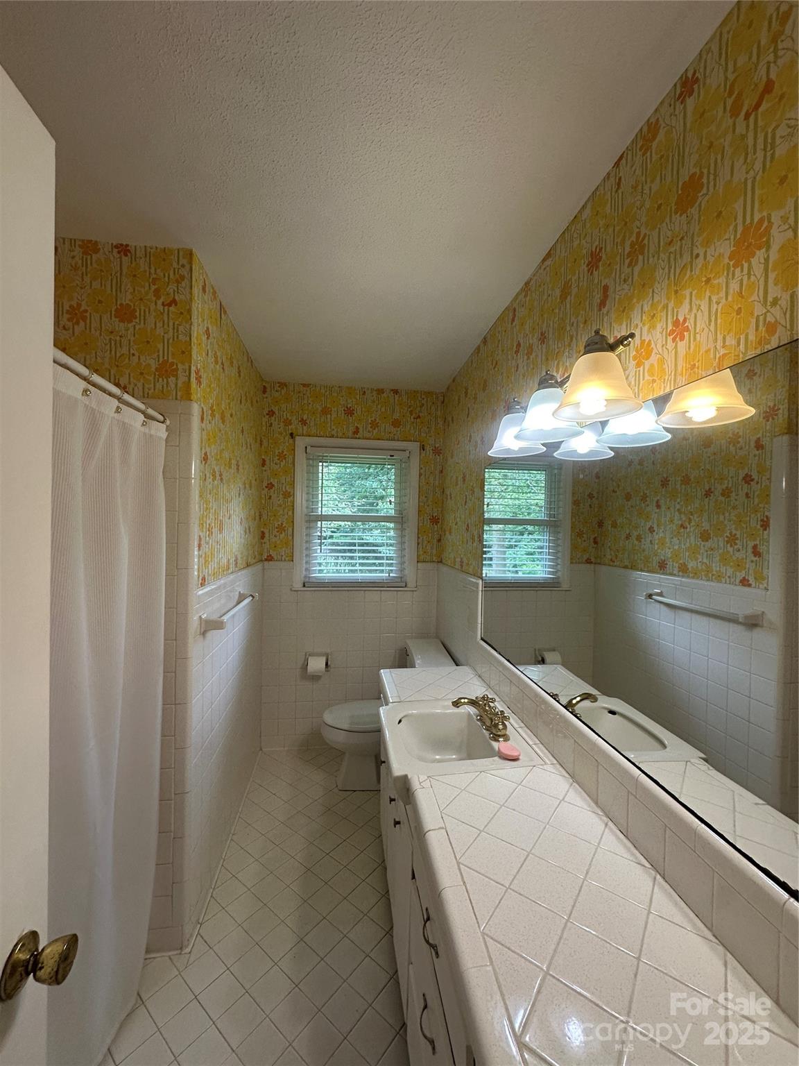 1115 Dumbarton Road Gastonia, NC 28054 - Photo 7 of 20 a room with a bed and a chandelier