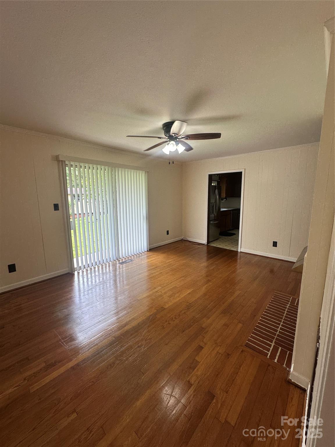 1115 Dumbarton Road Gastonia, NC 28054 - Photo 8 of 20 a view of an empty room with wooden floor and a window