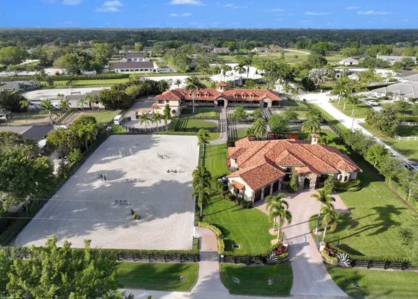 an aerial view of residential houses with outdoor space and street view