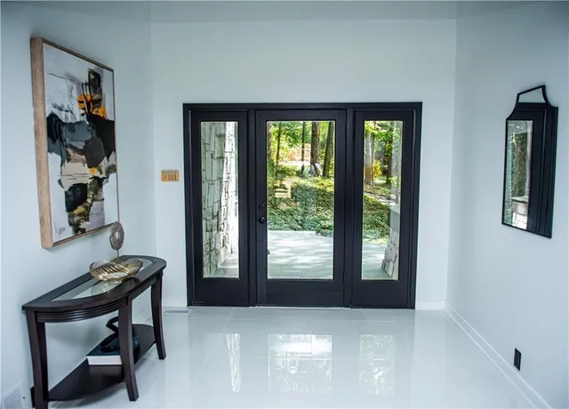 a kitchen with stainless steel appliances granite countertop a stove a refrigerator a sink dishwasher and white cabinets with wooden floor