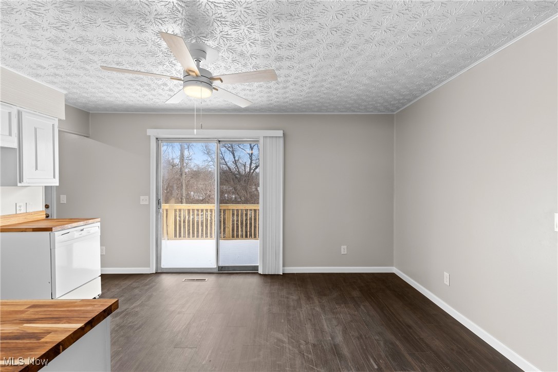 61899 Webb Heights Road Shadyside, OH 43947 - Photo 12 of 39 Unfurnished dining area featuring ceiling fan, dark hardwood / wood-style floors, and a textured ceiling