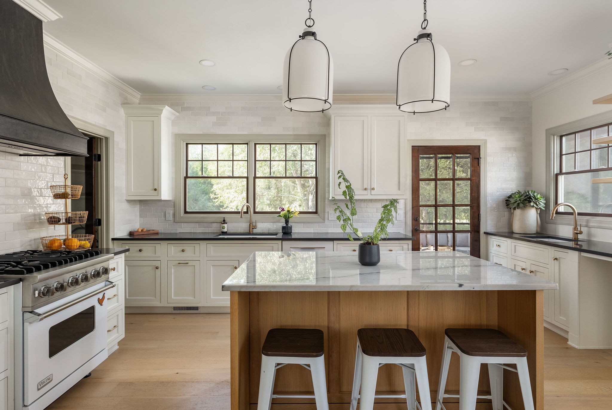 6238 Arno Road Franklin, TN 37064 - Photo 13 of 59 a kitchen with granite countertop a stove a sink cabinetry a dining table and chairs
