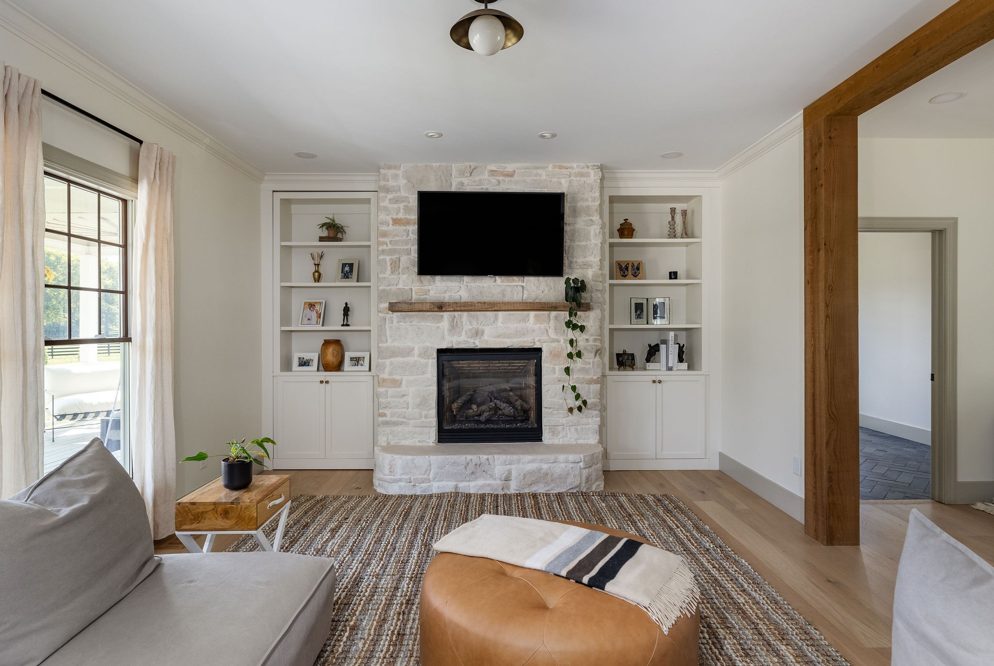 6238 Arno Road Franklin, TN 37064 - Photo 24 of 59 a living room with furniture a flat screen tv and a fireplace