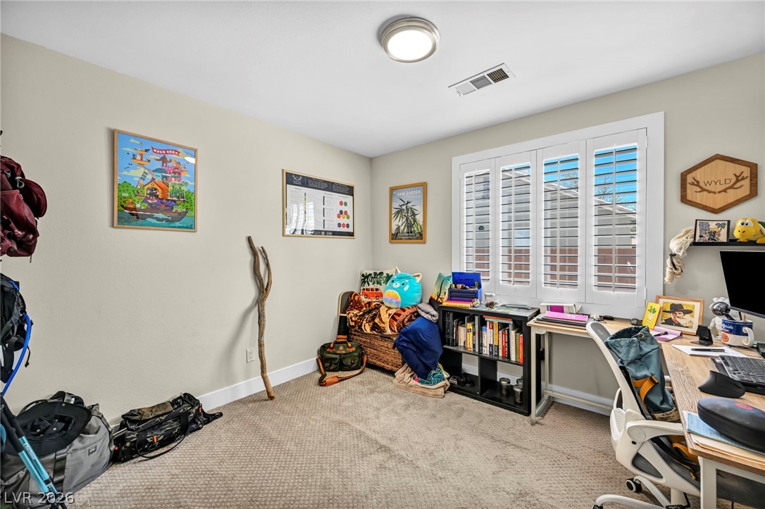1234 Sunfire Street Henderson, NV 89014 - Photo 21 of 40 A well-lit room featuring carpet flooring and bright windows.