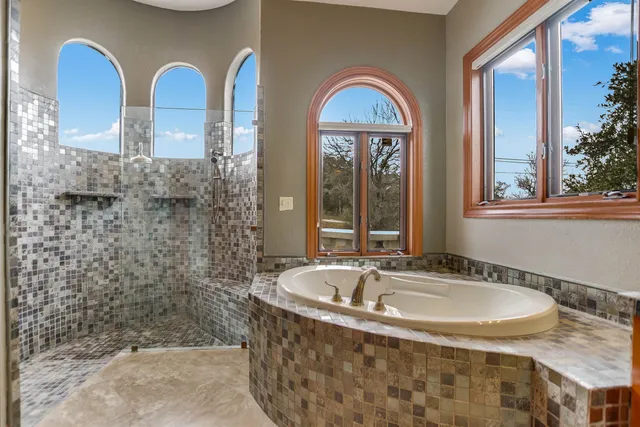 a bathroom with a tub and a shower