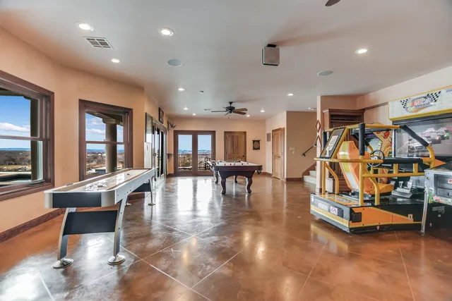 a view of a room with gym equipment and large windows