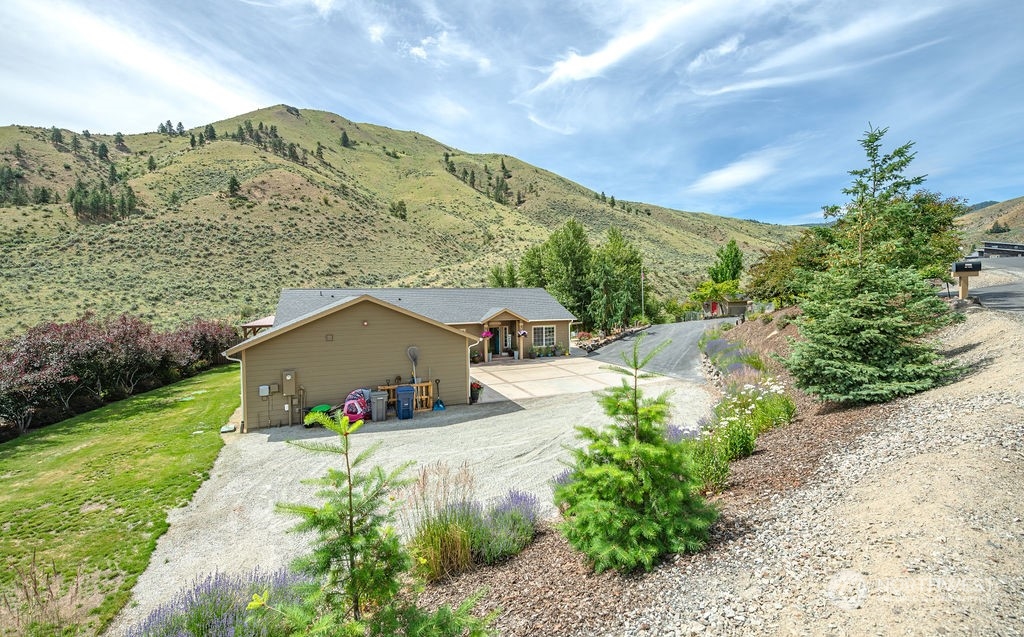 1365 Pitcher Canyon Road Wenatchee, WA 98801 - Photo 1 of 40 a front view of a house with a yard