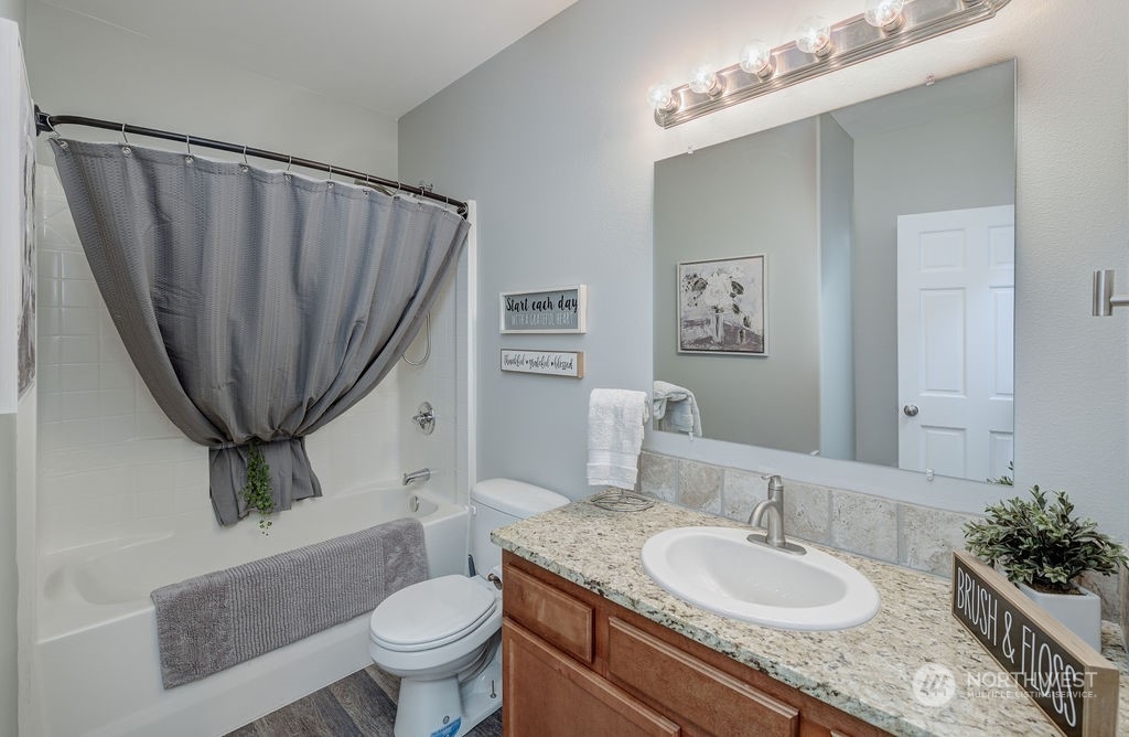 1365 Pitcher Canyon Road Wenatchee, WA 98801 - Photo 29 of 40 a bathroom with a granite countertop sink a toilet and a mirror