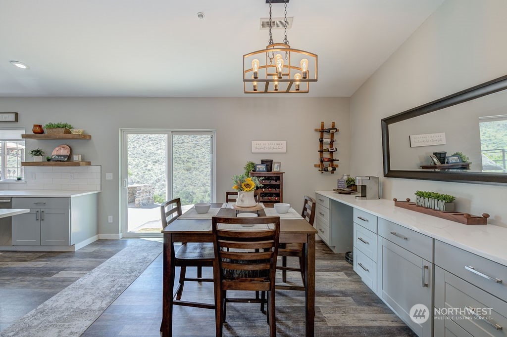 1365 Pitcher Canyon Road Wenatchee, WA 98801 - Photo 4 of 40 a view of a dining room with furniture a chandelier and wooden floor