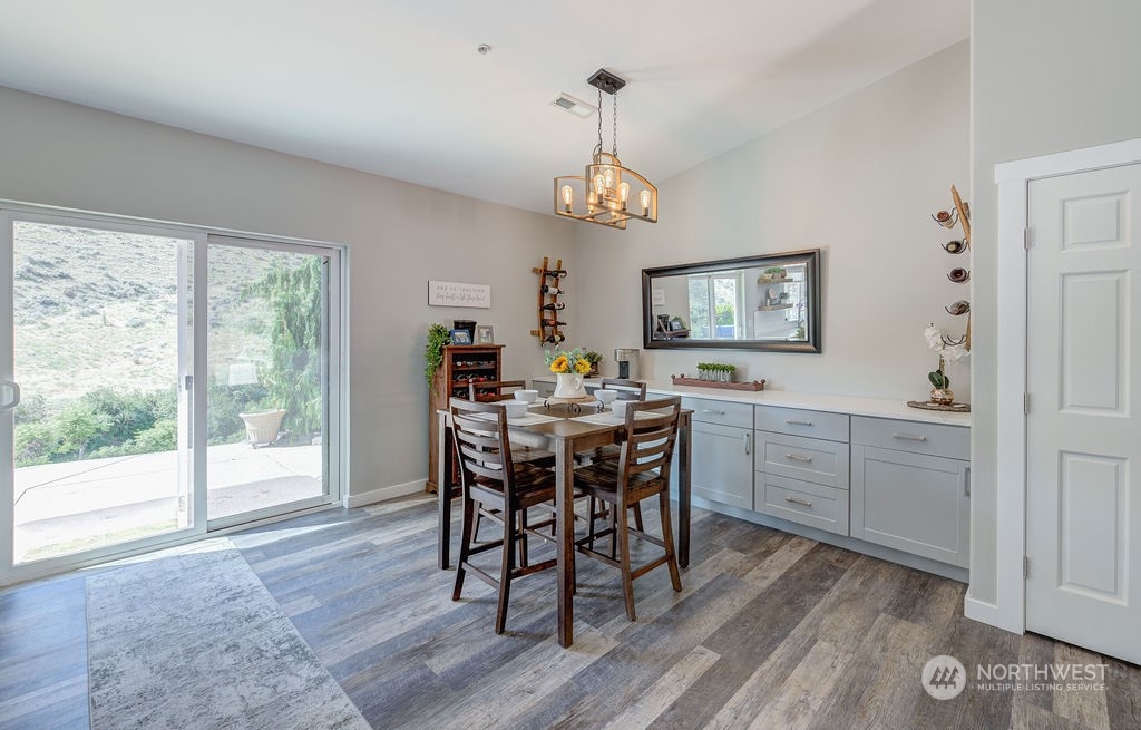 1365 Pitcher Canyon Road Wenatchee, WA 98801 - Photo 5 of 40 a view of a dining room with furniture window and wooden floor