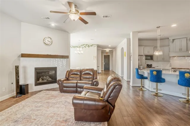 a living room with furniture a fireplace and a flat screen tv