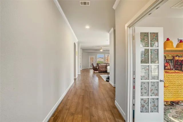 a view of hallway with wooden floor