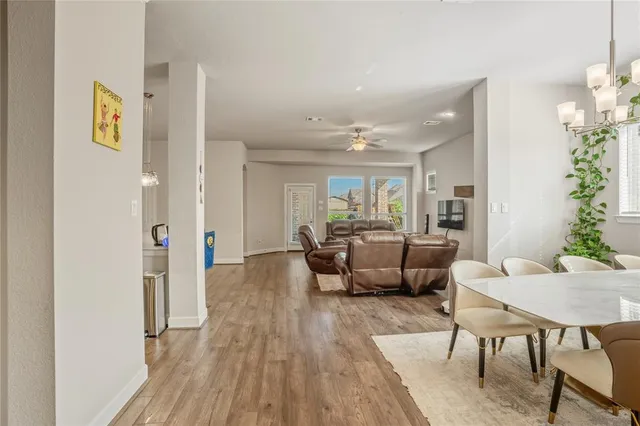 a view of a dining room with furniture and chandelier