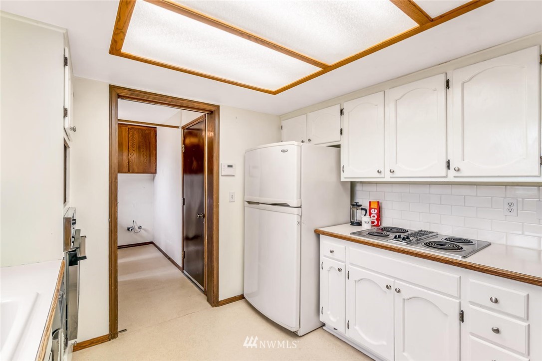 9513 Tveit Road Arlington, WA 98223 - Photo 12 of 40 a white refrigerator freezer sitting inside of a kitchen