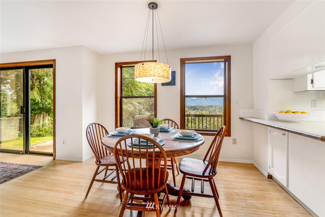 9513 Tveit Road Arlington, WA 98223 - Photo 15 of 40 a dining room with furniture window wooden floor