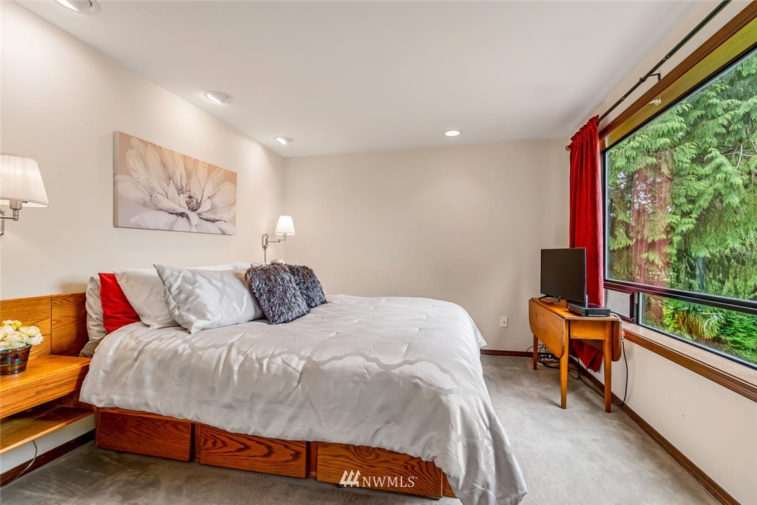 9513 Tveit Road Arlington, WA 98223 - Photo 19 of 40 a bedroom with a bed and a large window