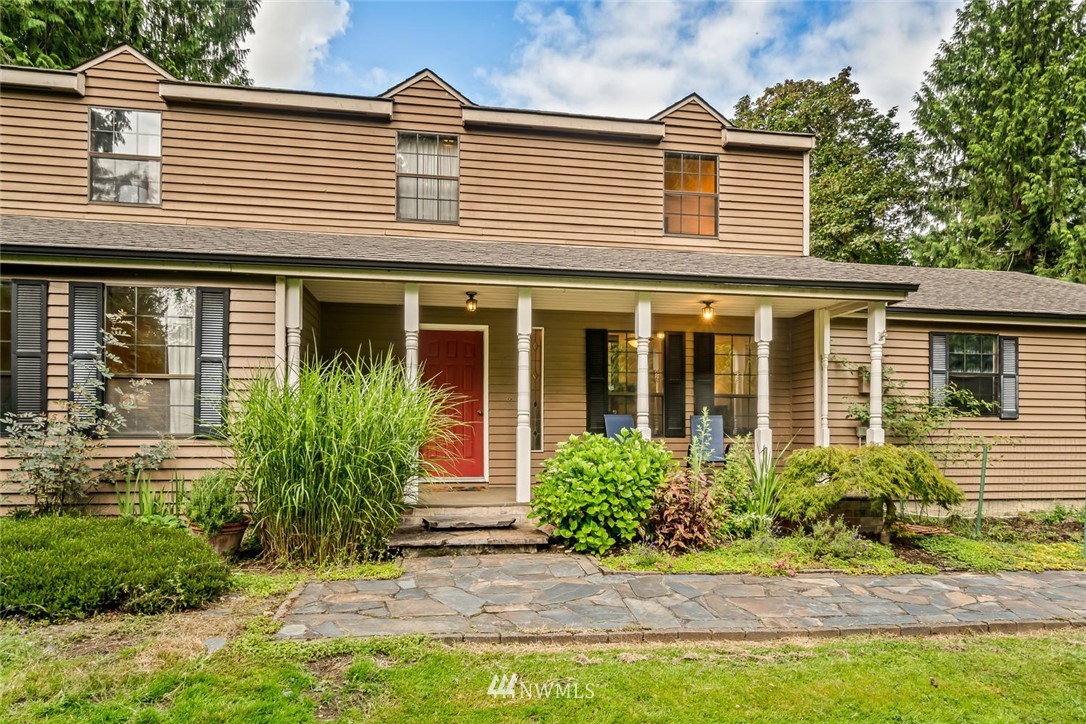 9513 Tveit Road Arlington, WA 98223 - Photo 3 of 40 a front view of a house with a yard and potted plants