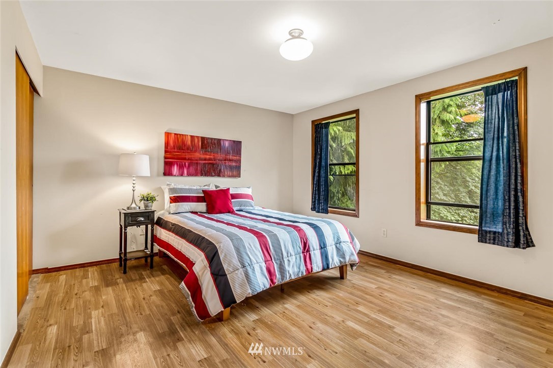9513 Tveit Road Arlington, WA 98223 - Photo 25 of 40 a bed sitting in a bedroom next to a window