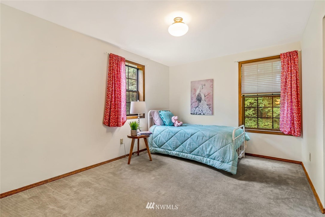 9513 Tveit Road Arlington, WA 98223 - Photo 26 of 40 a bedroom with a bed and a window
