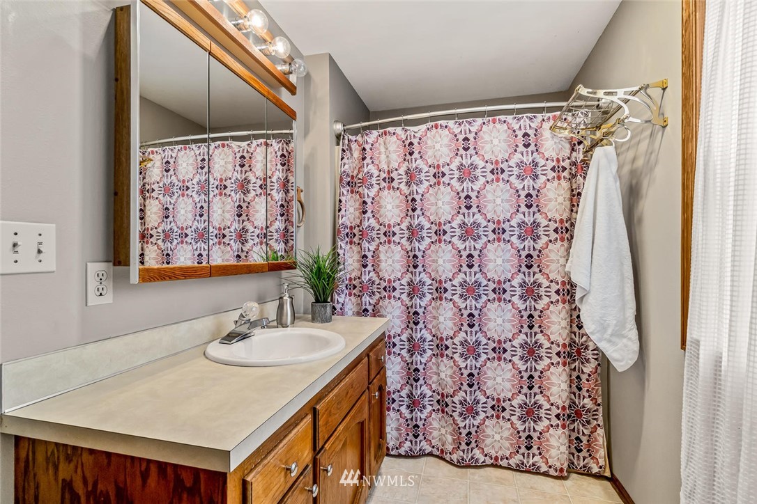 9513 Tveit Road Arlington, WA 98223 - Photo 27 of 40 a bathroom with a sink and a mirror