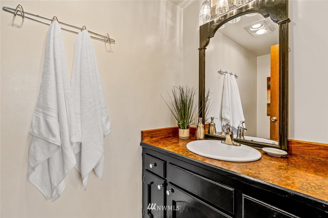 9513 Tveit Road Arlington, WA 98223 - Photo 28 of 40 a bathroom with a sink and mirror