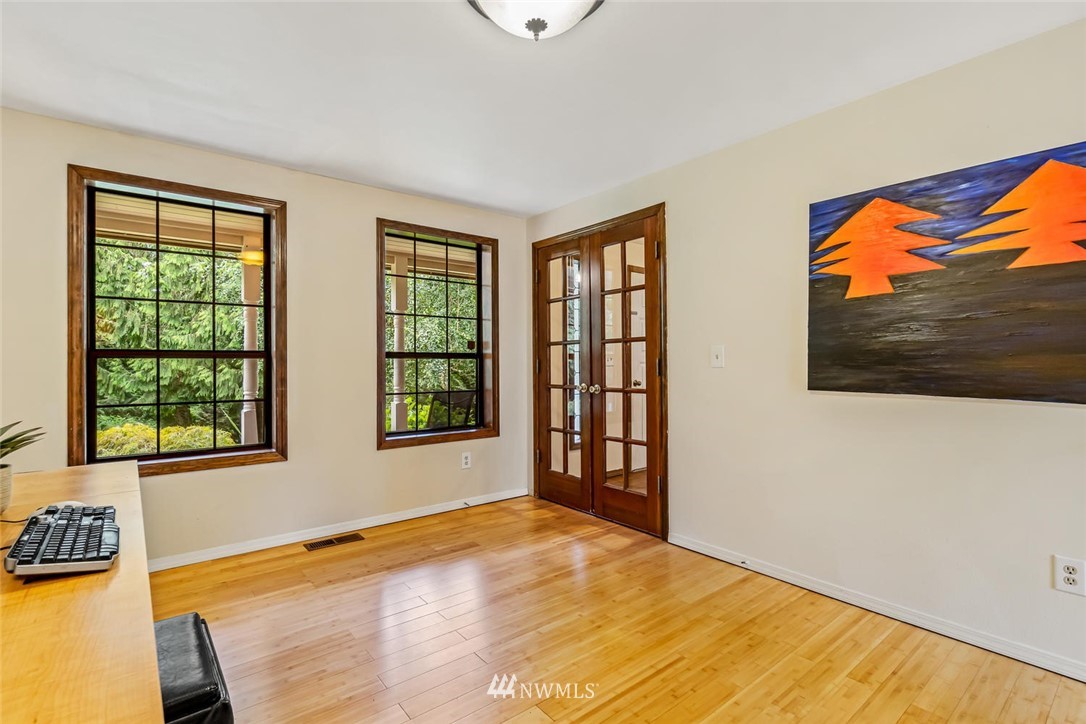 9513 Tveit Road Arlington, WA 98223 - Photo 30 of 40 a view of an empty room with a window and wooden floor
