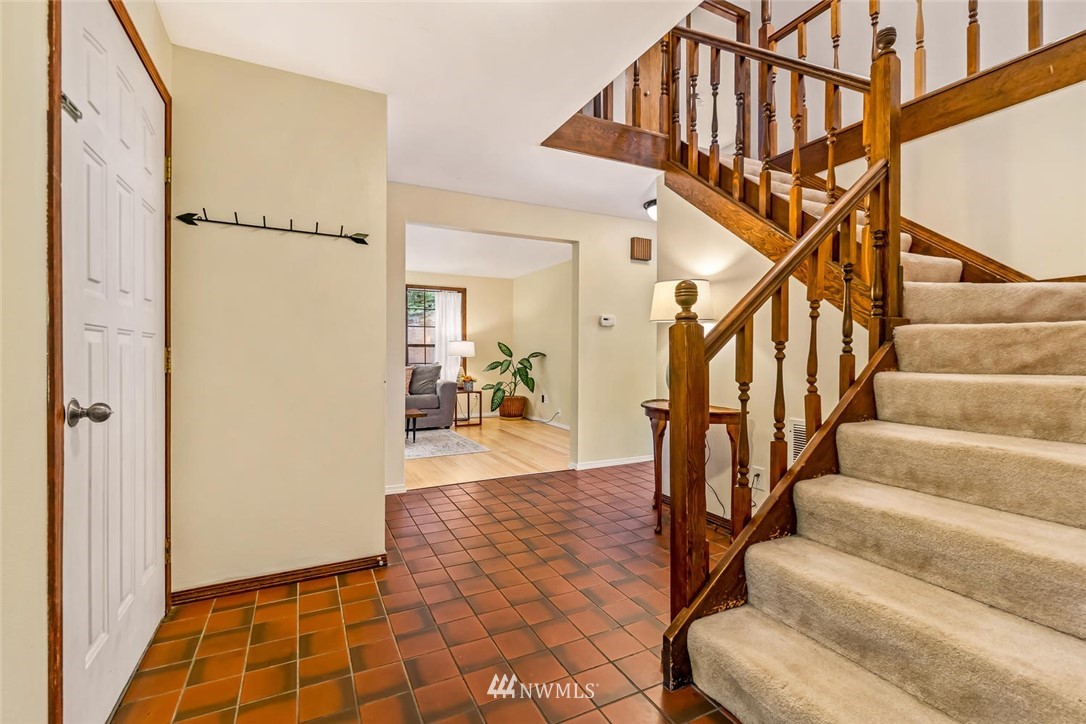 9513 Tveit Road Arlington, WA 98223 - Photo 6 of 40 a view of staircase with lots of frames on wall and a rug