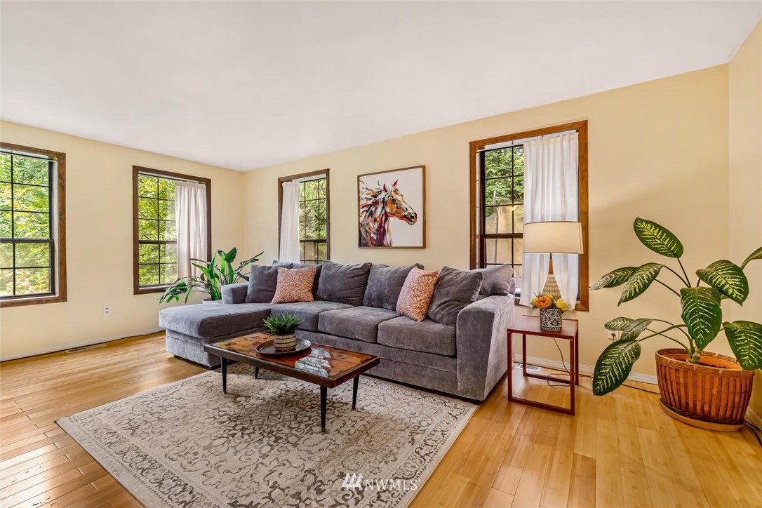 9513 Tveit Road Arlington, WA 98223 - Photo 8 of 40 a living room with furniture and a potted plant next to a window