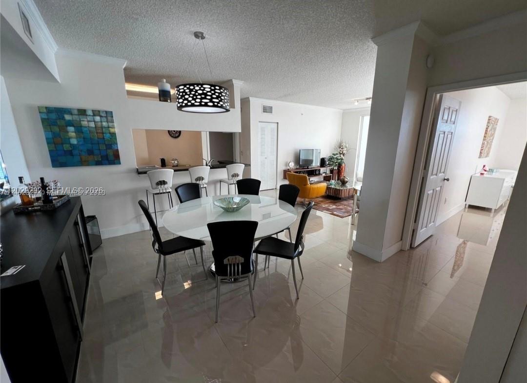 17100 North Bay Road, Unit 1605 Sunny Isles Beach, FL 33160 - Photo 12 of 52 a view of a dining room with furniture window and wooden floor