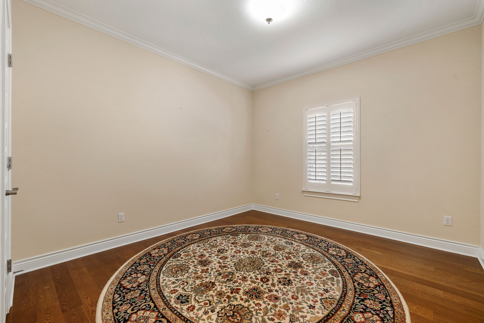 5201 Big Spring Street Georgetown, TX 78633 - Photo 18 of 26 Spare room with crown molding and dark wood-style flooring
