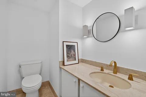 a bathroom with a toilet a sink and a mirror