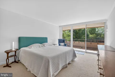 a bedroom with a bed and a lamp next to a window