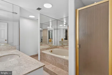 a bathroom with a tub sink and shower