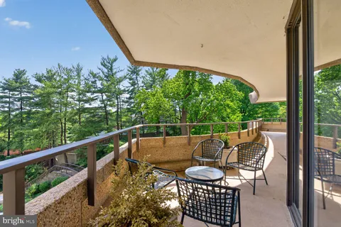 a view of balcony with furniture and garden