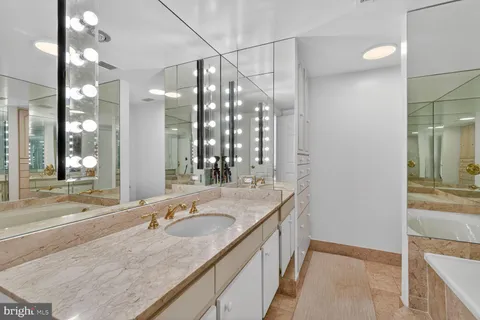 a bathroom with double vanity sinks and a mirror