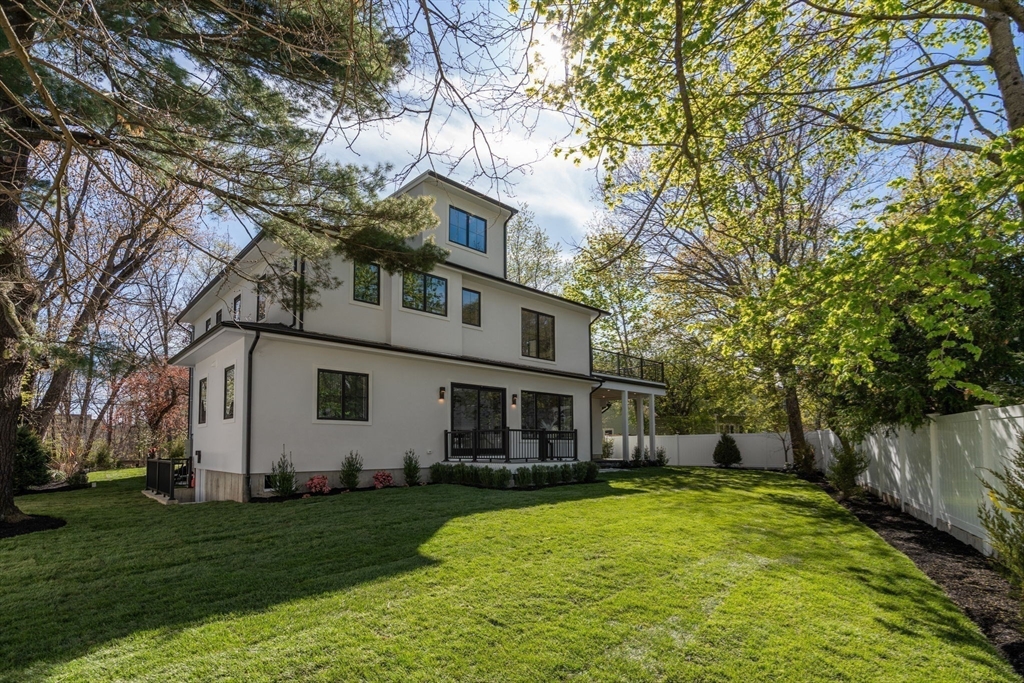 470 Quinobequin Road Newton, MA 02468 - Photo 33 of 37 a front view of a house with a yard and trees