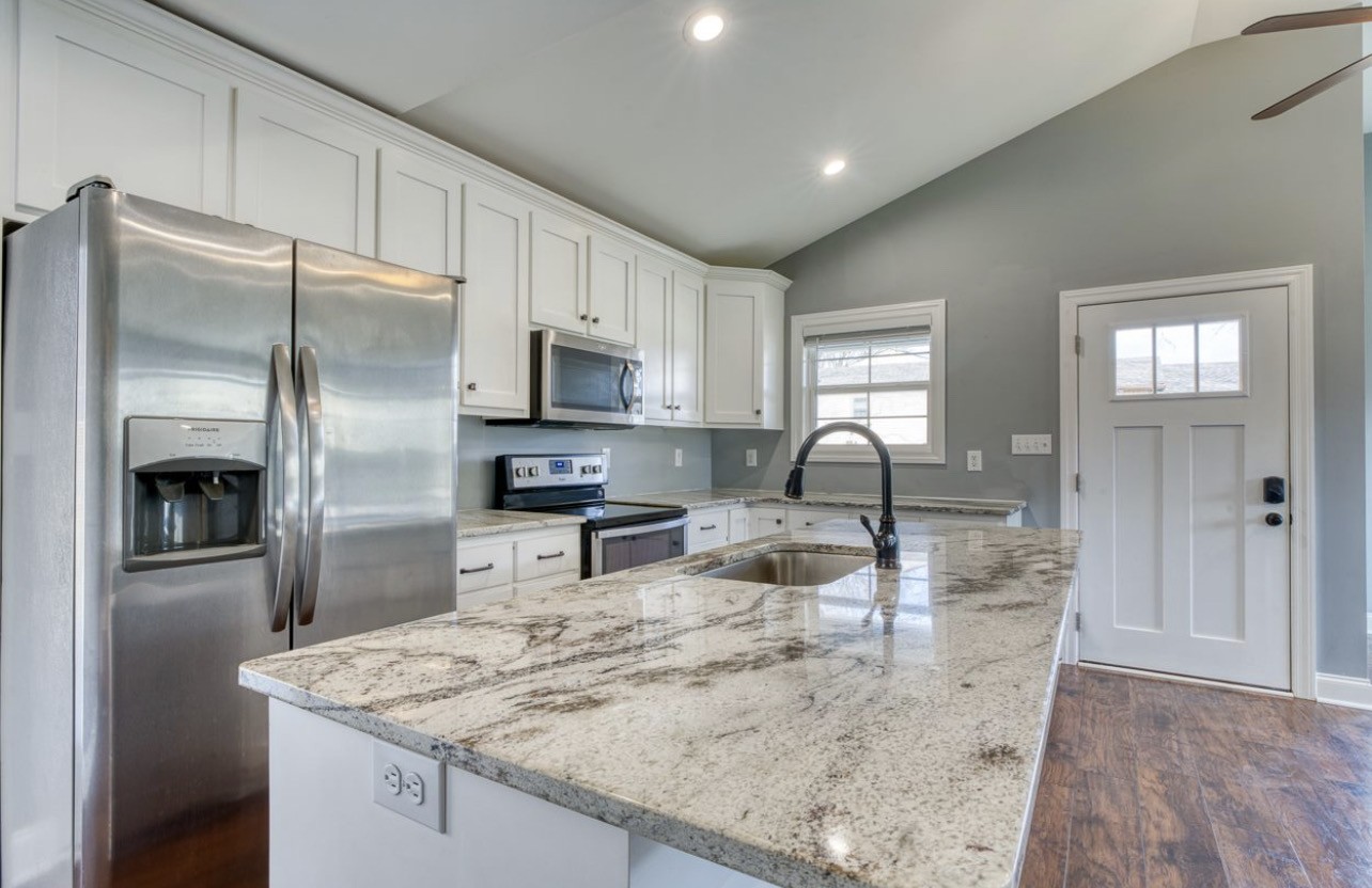 807 Clear Creek Road Pulaski, TN 38478 - Photo 4 of 17 a kitchen with stainless steel appliances granite countertop a sink a stove and a refrigerator