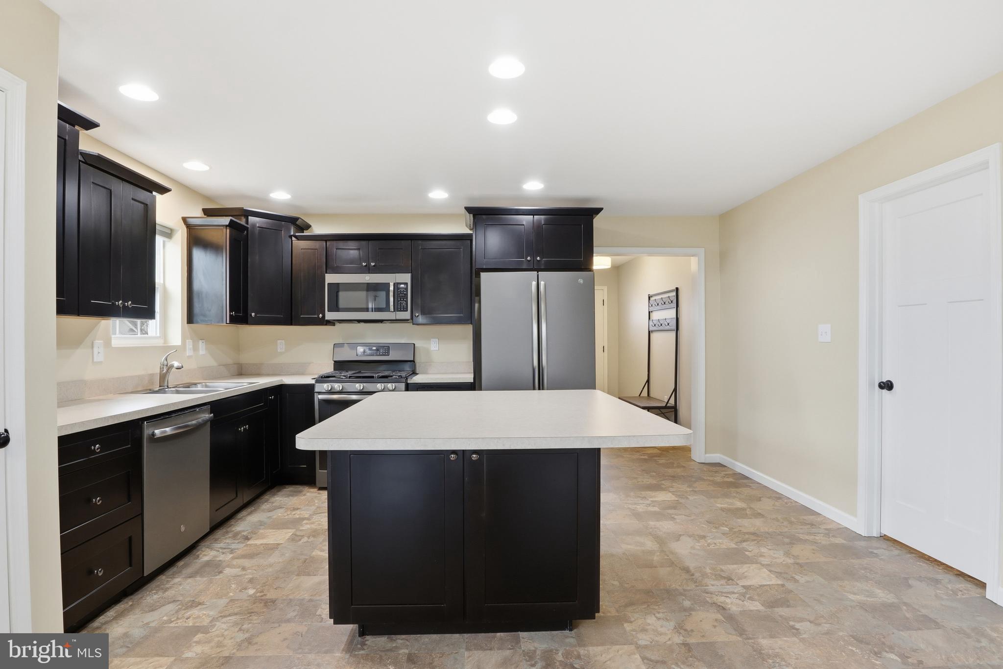 2606 Woodspring Drive York, PA 17402 - Photo 12 of 60 a large kitchen with kitchen island a sink stainless steel appliances and cabinets