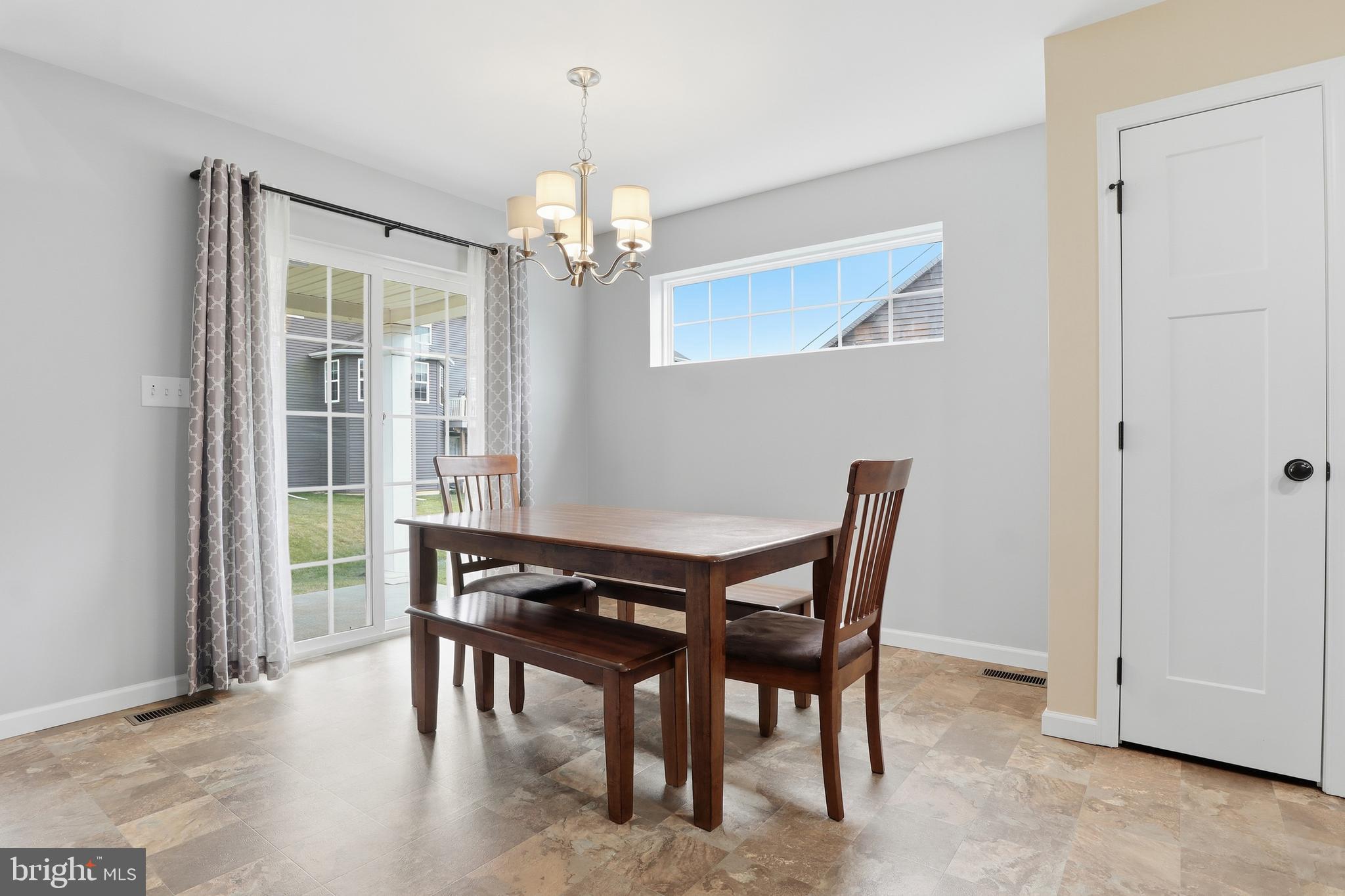 2606 Woodspring Drive York, PA 17402 - Photo 16 of 60 a view of a dining room with furniture wooden floor and chandelier