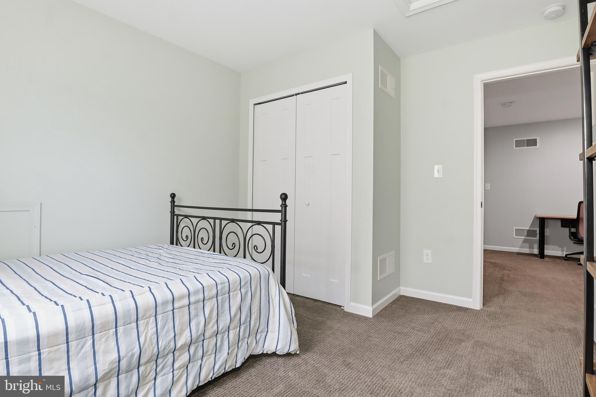 2606 Woodspring Drive York, PA 17402 - Photo 30 of 60 a bedroom with a bed and a table in it