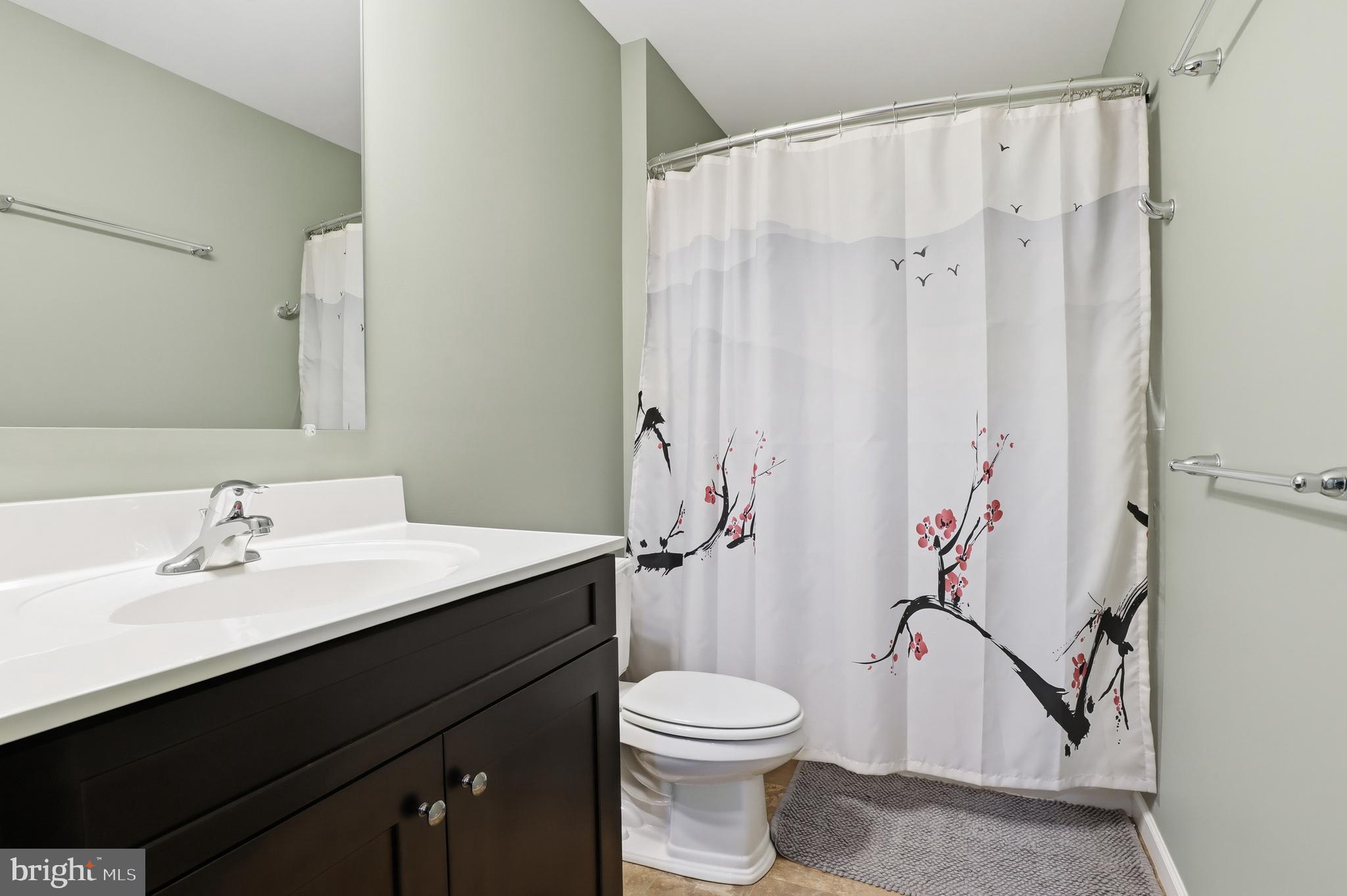 2606 Woodspring Drive York, PA 17402 - Photo 31 of 60 a bathroom with a sink a toilet and shower curtain